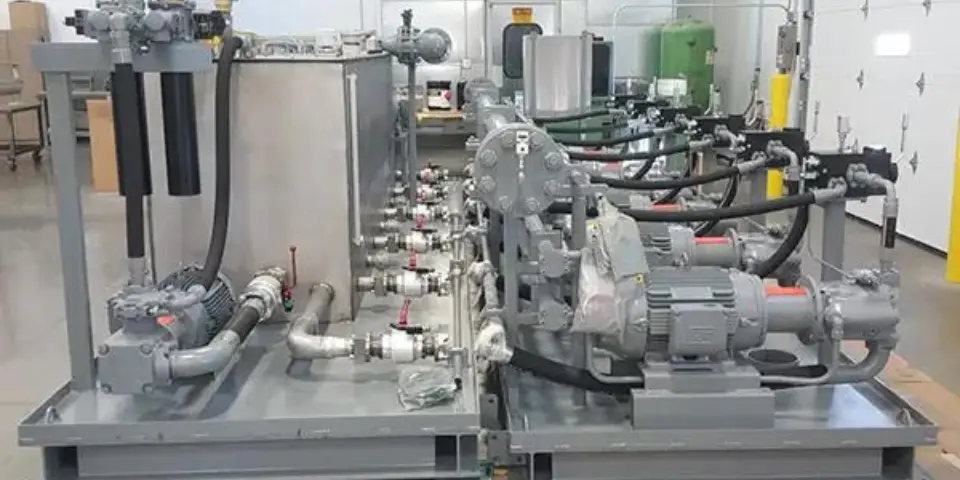 Close-up image of a large hydraulic power unit within a clean facility with bright lighting