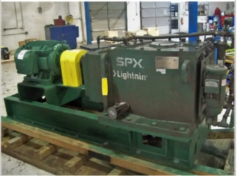 The large green and yellow gearbox sent in for repairs in Motion Repair & Services facility