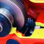 A peek at several gears inside a red powder coated gearbox assembled by Motion service experts